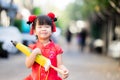 Beautiful Asian girl holding umbrella with closed  yellow vintage style. Children smile sweet and happy. Royalty Free Stock Photo