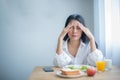 Beautiful asian girl let out a deep sigh as she realized she had lost her appetite due to the stress.