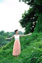 Beautiful asian girl playing in the grass