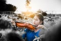 Asian girl playing violin in mist of sun flower field Royalty Free Stock Photo