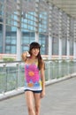 Beautiful Asian girl showing youthful vigor on the pedestrian bridge Royalty Free Stock Photo
