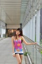 Beautiful Asian girl showing youthful vigor on the pedestrian bridge Royalty Free Stock Photo