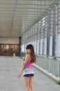 Beautiful Asian girl showing youthful vigor on the pedestrian bridge Royalty Free Stock Photo