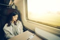Beautiful asian girl sleeping on the train while listening to music, with copy space, soft warm light tone Royalty Free Stock Photo