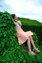 Beautiful Asian girl strolls in the plant wall Royalty Free Stock Photo