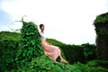 Beautiful Asian girl strolls in the plant wall