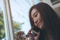 A beautiful Asian girl talking on smart phone with smiley face Royalty Free Stock Photo