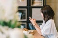 Beautiful Asian girl using smartphone at cafe with chocolate toast and ice cream. Coffee shop dessert and modern casual lifestyle