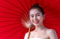 Beautiful Asian girl wearing traditional northern dress costume holding red umbrella as countryside, Thai Woman in Traditional Royalty Free Stock Photo