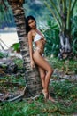 Beautiful asian girl in white bikini posing at the tropical beach Royalty Free Stock Photo