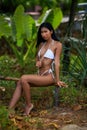 Beautiful asian girl in white bikini posing at the tropical beach Royalty Free Stock Photo