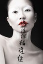 Beautiful Asian girl with white skin, red lips and Royalty Free Stock Photo