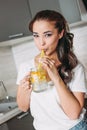 The beautiful asian girl young woman drinking glass jar with lemon water in kitchen, close up Royalty Free Stock Photo