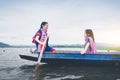 Beautiful Asian girls on fishing boat in lake to catch fish