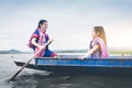 Beautiful Asian girls on fishing boat in lake to catch fish