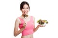 Beautiful Asian healthy girl enjoy eating salad. Royalty Free Stock Photo