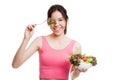 Beautiful Asian healthy girl enjoy eating salad. Royalty Free Stock Photo