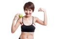 Beautiful Asian healthy girl flexing biceps with green apple.