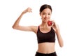 Beautiful Asian healthy girl flexing biceps with red apple Royalty Free Stock Photo