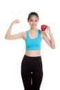 Beautiful Asian healthy girl flexing biceps with red apple Royalty Free Stock Photo