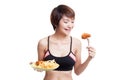 Beautiful Asian healthy girl with french fries and fired chicke Royalty Free Stock Photo