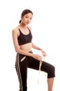 Beautiful Asian healthy girl measuring her leg Royalty Free Stock Photo