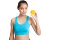 Beautiful Asian healthy girl with orange fruit licks her lips Royalty Free Stock Photo