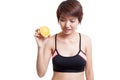 Beautiful Asian healthy girl with orange fruit licks her lips. Royalty Free Stock Photo