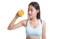 Beautiful Asian healthy girl with orange fruit licks her lips. Royalty Free Stock Photo