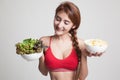 Beautiful Asian healthy girl salad and potato chips. Royalty Free Stock Photo