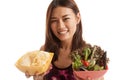 Beautiful Asian healthy girl salad and potato chips. Royalty Free Stock Photo