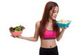 Beautiful Asian healthy girl salad and potato chips. Royalty Free Stock Photo