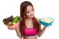 Beautiful Asian healthy girl salad and potato chips. Royalty Free Stock Photo