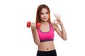 Beautiful Asian healthy girl show OK with dumbbell.