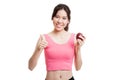 Beautiful Asian healthy girl thumbs up with apple. Royalty Free Stock Photo