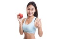 Beautiful Asian healthy girl thumbs up with red apple. Royalty Free Stock Photo