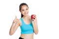 Beautiful Asian healthy girl thumbs up with red apple Royalty Free Stock Photo