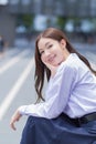 Beautiful Asian high school student girl in the school uniform with braces on her teeth .sits and smiles confidently while she Royalty Free Stock Photo