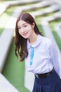 Beautiful Asian high school student young girl in the school uniform with braces on her teeth stands and smiles confidently while Royalty Free Stock Photo