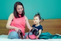 A beautiful Asian lady mother is pregnant. Take a big headset Come to the stomach Let the child in the belly listen Have a little Royalty Free Stock Photo