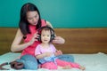 A beautiful Asian lady mother is pregnant. Take a big headset Come to the stomach Let the child in the belly listen Have a little Royalty Free Stock Photo