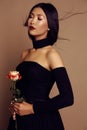 Beautiful asian look girl with black hair wearing elegant dress