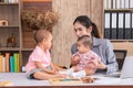 Beautiful Asian mother confuse multi task, single mom cannot work while kids playing, work from home fussy taking care chaotic Royalty Free Stock Photo