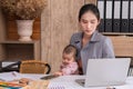 Beautiful Asian mother confuse multi task while work at home, women work from home fussy taking care child in quarantine social