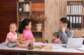 Beautiful Asian mother confuse multi task while work at home, women work from home fussy taking care children in quarantine social