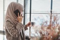 Beautiful asian muslim business woman brown hijab standing and talking with her phone at modern office Royalty Free Stock Photo