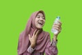 beautiful muslim woman feeling refreshed after drinking water with green background