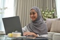 Beautiful Asian Muslim woman using laptop computer Royalty Free Stock Photo