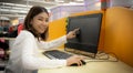 Beautiful asian office woman demonstrates computer performance in corporate office