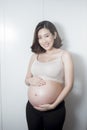 Beautiful asian pregnant woman expecting  baby and touching her belly Royalty Free Stock Photo